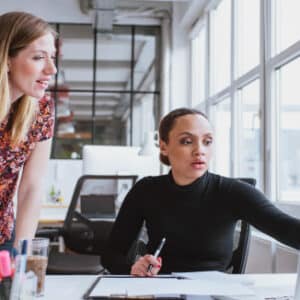 Image of two people working together at the computer for Coaching Strategies for Leaders
