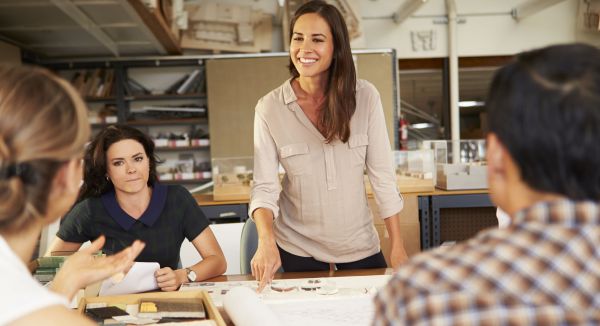 Image of leader talking with people at work for Leadership Management Certificate Program