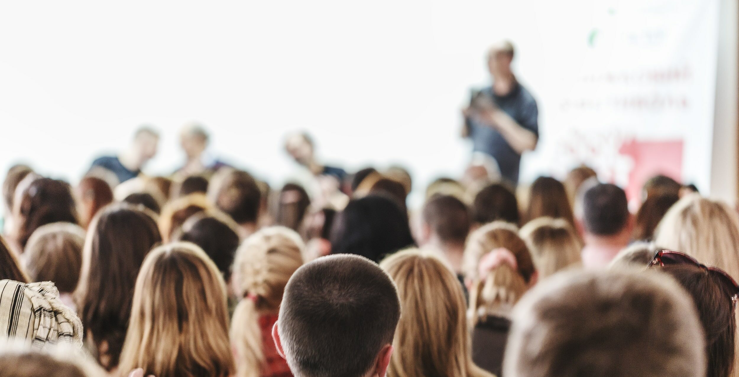 Photo of people listening to trainer at a live training certificate program